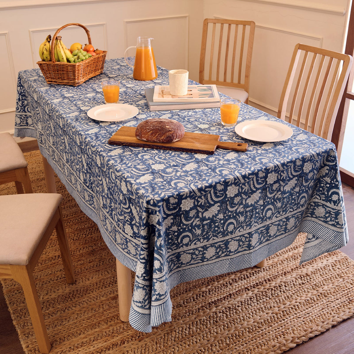 Blue block-print cotton tablecloth on a dining table set for a festive meal