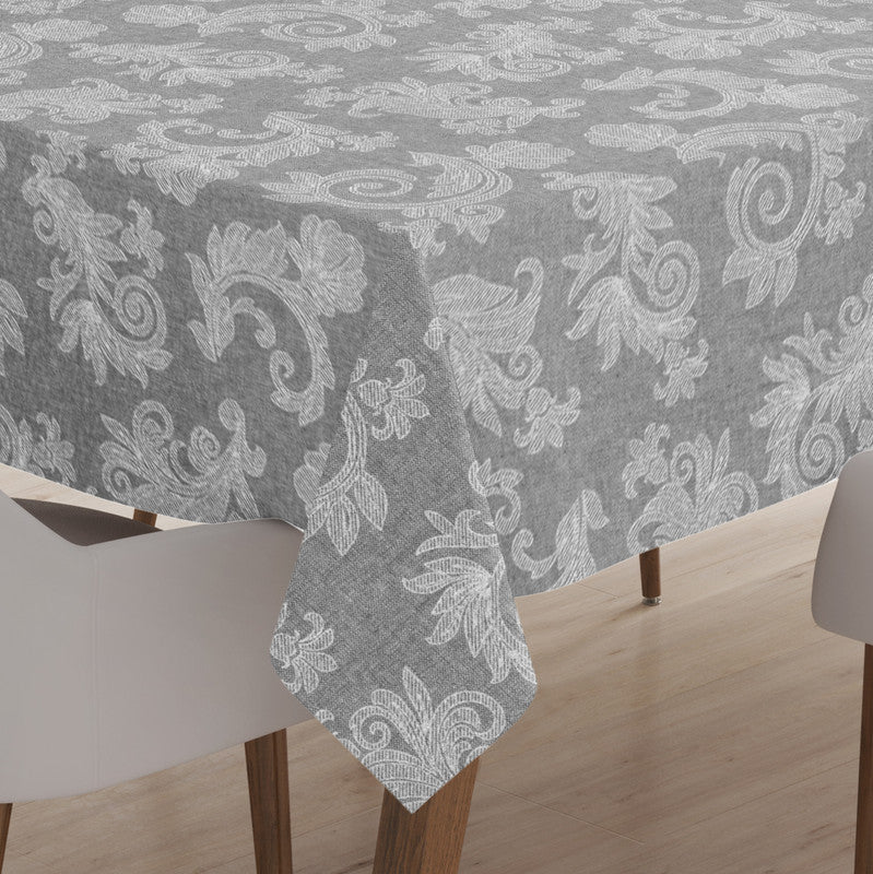 Grey chambray cotton round tablecloth laid over a wooden dining table