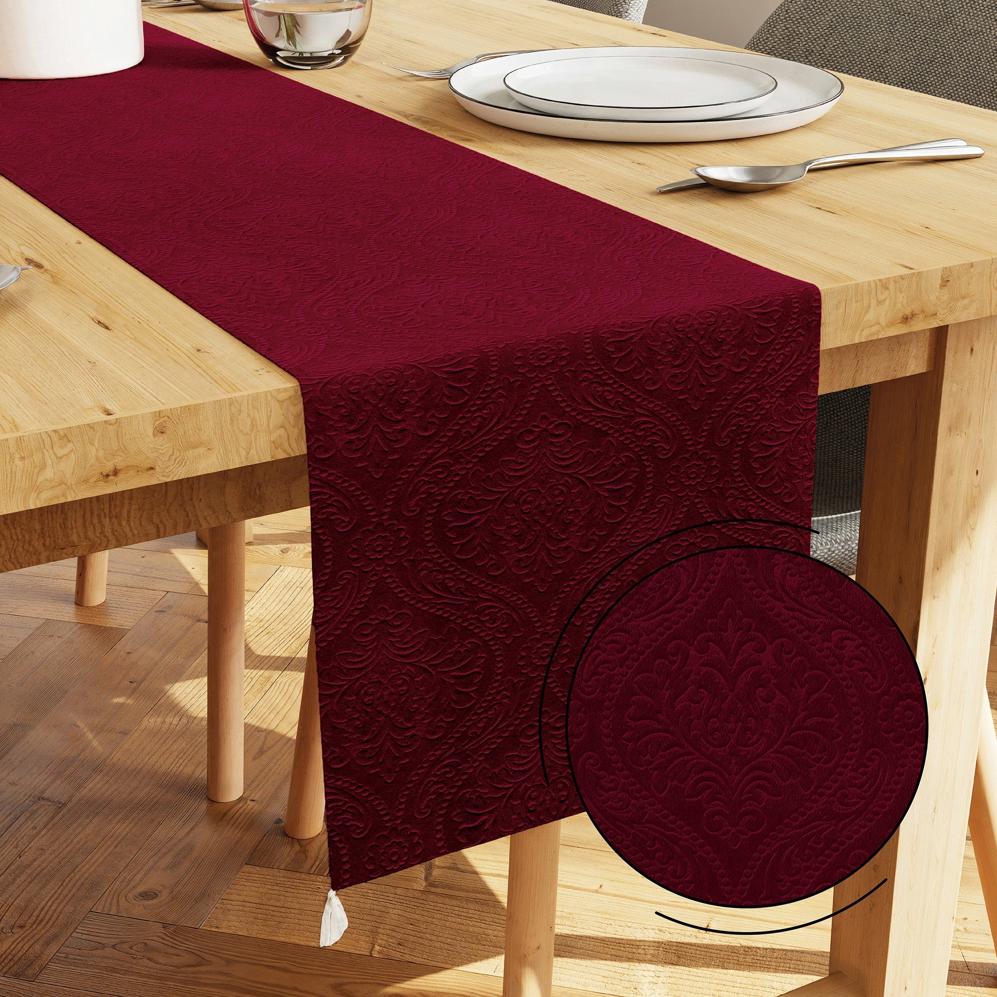 Embossed maroon velvet table runner styled on a wedding-season dining table