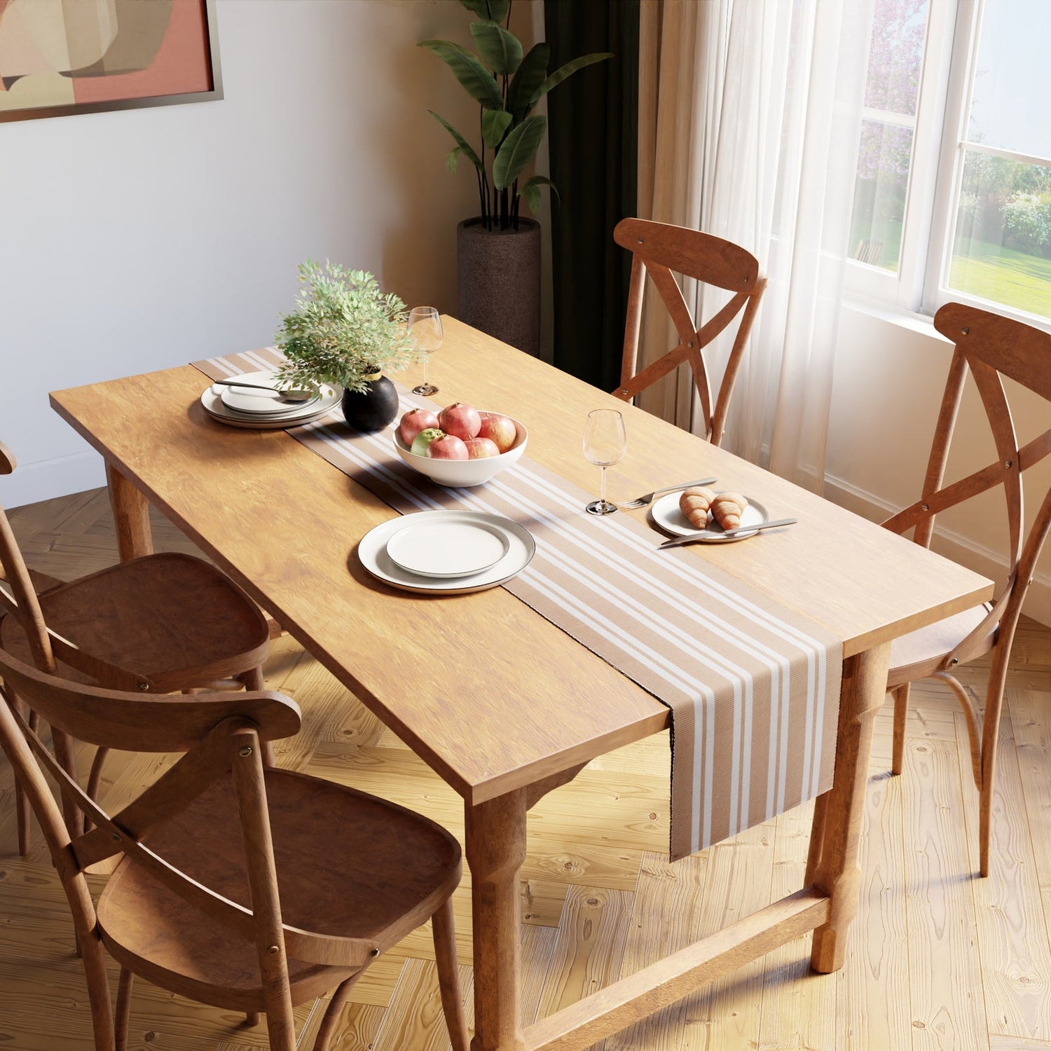 Striped cotton table runner and plates on a wooden dining table in a sunlit room